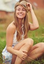 Find happiness in the simplest things. a young woman sitting in a field in the countryside. Royalty Free Stock Photo