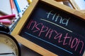 Find inspiration on phrase colorful handwritten on chalkboard, alarm clock with motivation and education concepts.