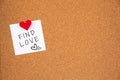 Find love letter on white paper fastened to the left with red heart pushpin on cork board