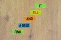 Find a need and fill it symbol. Concept words Find a need and fill it on color papers on a beautiful wooden background. Business