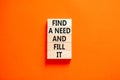 Find a need and fill it symbol. Concept words Find a need and fill it on wooden blocks on a beautiful orange table orange