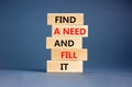 Find a need and fill it symbol. Concept words Find a need and fill it on wooden blocks on a beautiful grey table grey background.