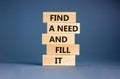 Find a need and fill it symbol. Concept words Find a need and fill it on wooden blocks on a beautiful grey table grey background.