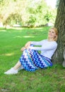 Find peaceful place in park. Give yourself break and enjoy leisure. Girl sit on grass lean on tree trunk relaxing in Royalty Free Stock Photo