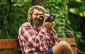 Find perfect angle. Man with retro camera. Photography in modern life. Photographer use vintage camera. Bearded man