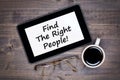 Find the right people! Text on tablet device on table Royalty Free Stock Photo