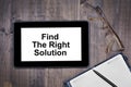 Find the right solution. Text on tablet device on desk Royalty Free Stock Photo