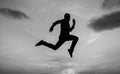 Find your freedom. personal achievement goal. man silhouette jump on sky background. confident businessman running