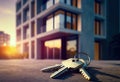 Find your ideal home: close-up of apartment keys in front of a new building. Concept: buying an apartment, renting a house, real