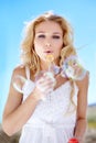 Find your inner child. Pretty young woman blowing bubbles right at you. Royalty Free Stock Photo