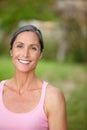 Finding calm is essential to wellness. Portrait of an attractive mature woman in gymwear standing outdoors.