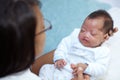 Finding comfort in the arms of her mother. Shot of a sleeping baby girl with a cleft palate being held by her mother. Royalty Free Stock Photo