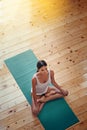 Finding her inner peace. High angle shot of a young woman doing yoga indoors. Royalty Free Stock Photo