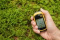 Finding the right position in the forest with a gps Royalty Free Stock Photo