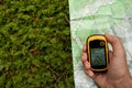 Finding the right position in the forest with a map and GPS Royalty Free Stock Photo