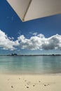 Finding shade under umbrella at the beach, Nassau, Bahamas