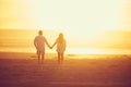 Finding their own paradise. Rearview shot of an affectionate mature couple walking hand in hand on the beach. Royalty Free Stock Photo