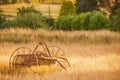 Fine art, artwork. Digital abstract oil painting of an antique hay rake in a farmers field at sunset Royalty Free Stock Photo