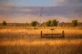 Fine art, artwork. Digital abstract oil painting of an antique hay rake in a farmers field at sunset Royalty Free Stock Photo