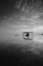 Fine art Black & white image of beautiful landscape of the beach at morning. Fisherman boat and clouds reflecting in the water. Royalty Free Stock Photo