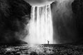 Woman practicing yoga at the Skogafoss waterfall