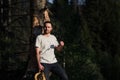 Fine art portrait of a hipster man wearing sunglasses in a forest. Royalty Free Stock Photo