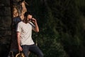 Fine art portrait of a hipster man wearing sunglasses in a forest. Royalty Free Stock Photo