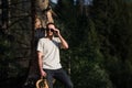 Fine art portrait of a hipster man wearing sunglasses in a forest. Royalty Free Stock Photo