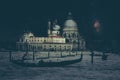 Fine art retro image with gondola on Canal Grande at night with wood planks floor for foreground, full moon and milky, Venice, It Royalty Free Stock Photo