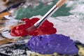 Fine art school. Closeup of artist hands holding wooden palette, mixing acrylic paint with brush