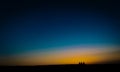 Fine art style image of three people waiting for the sunset Royalty Free Stock Photo