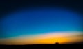 Fine art style image of three people waiting for the sunset Royalty Free Stock Photo