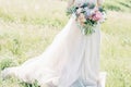 Fine art wedding photography. Beautiful bride with bouquet and dress with train in nature Royalty Free Stock Photo