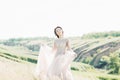 Fine art wedding photography. Beautiful bride with bouquet and dress with train in nature Royalty Free Stock Photo