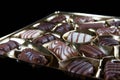 Fine assorted brown white chocolate pralines on golden package