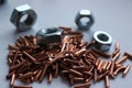 Fine-cut copper of high quality and steel nuts. Royalty Free Stock Photo