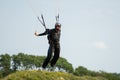 A fine day during vacation time. Many practices their favorite sport. Picture of a skydiver landing after a skydive