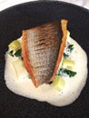 Sea bass with leeks and spinach on a seafood foam Royalty Free Stock Photo