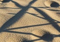 Fine golden sand with intricate shadow patterns cast by slender twigs Royalty Free Stock Photo