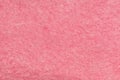 Fine grain pink matte background of suede fabric. Velvet texture of coral woolen felt Royalty Free Stock Photo
