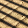 Close up shot of textured golden sand with strong linear shadow lines Royalty Free Stock Photo