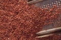 Fine grated dark chocolate on grater Royalty Free Stock Photo