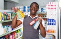 Fine man holding bottles of carbonated drinks