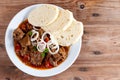 Fine Meat - Beef Goulash in a with Red Pepper on table. Top view. Copy space