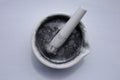 Fine particles of aluminum on the surface of the water in a ceramic mortar and pestle. Royalty Free Stock Photo