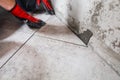 Fine precise accurate work of a tiler when laying tiles on the floor Royalty Free Stock Photo