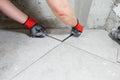 Fine precise accurate work of a tiler when laying tiles on the floor Royalty Free Stock Photo