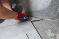 Fine precise accurate work of a tiler when laying tiles on the floor Royalty Free Stock Photo