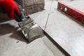 Fine precise accurate work of a tiler when laying tiles on the floor Royalty Free Stock Photo