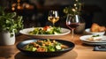 Fine restaurant dinner table place setting: napkin, wineglass, plate, bread and salad. Royalty Free Stock Photo